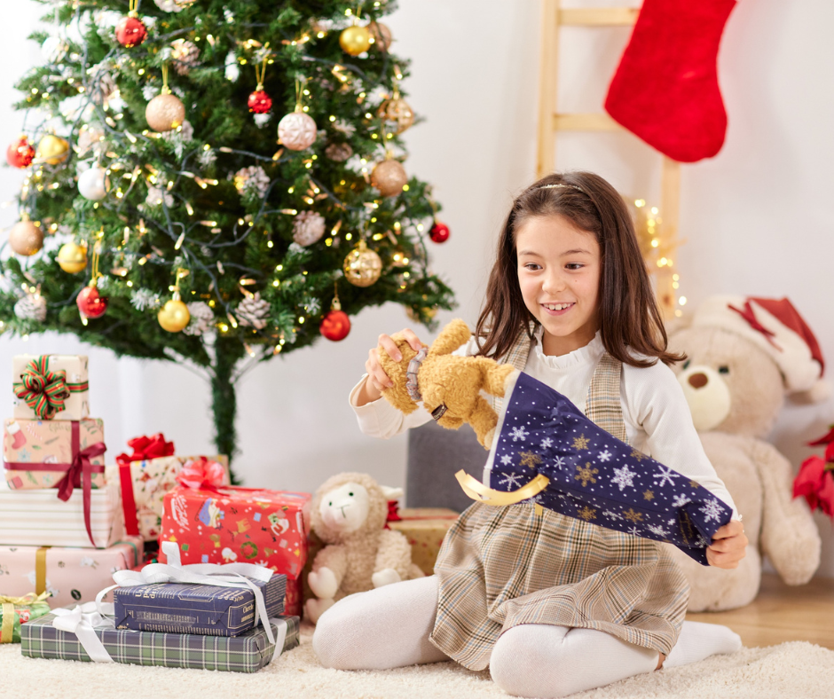 Young child with Christmas stocking gifts